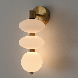 Wall-mounted light fixture with three glass shades on a gray wall.