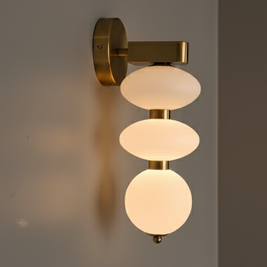 Wall-mounted light fixture with three round glass shades on a plain wall.