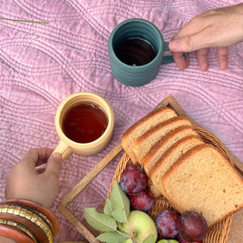 Buttercup ceramic mug styled on a cosy picnic blanket, outdoorsy but perfect for soft home vibes