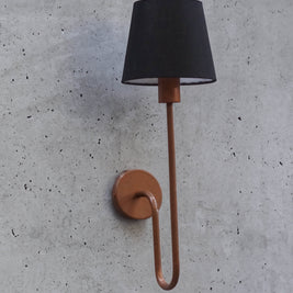 Stylish wall-mounted lamp with a black lampshade and luxurious copper metal arm, adding a touch of sophistication.