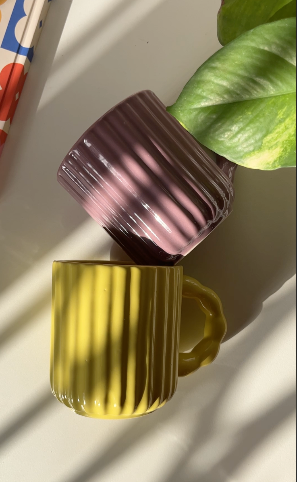 Sculptural fluted ceramic mug with glossy surface
