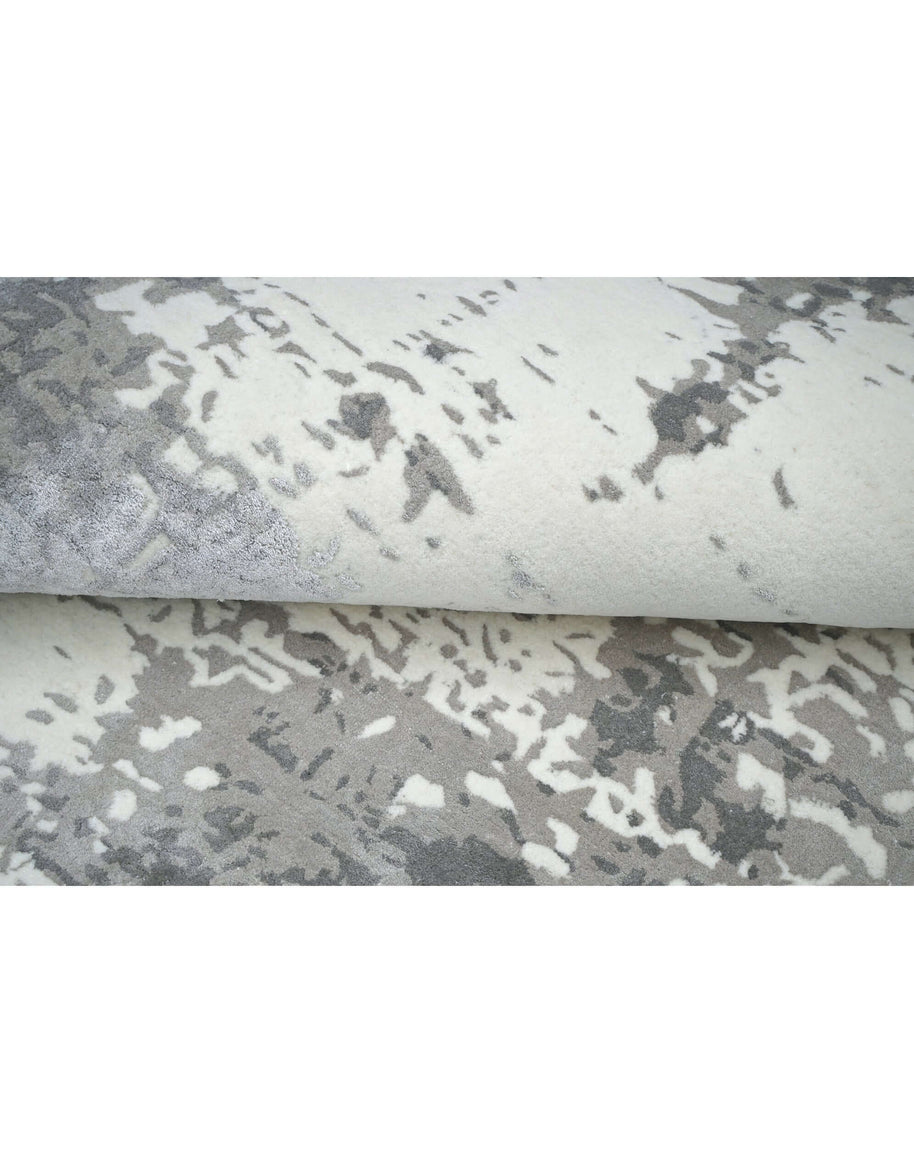 I N A V I luxury handmade rug by Cherom in New Zealand wool, featuring abstract grey and ivory design.