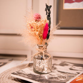 Close-up view of silver blossom charm vase featuring beautifully arranged dried flower bouquet