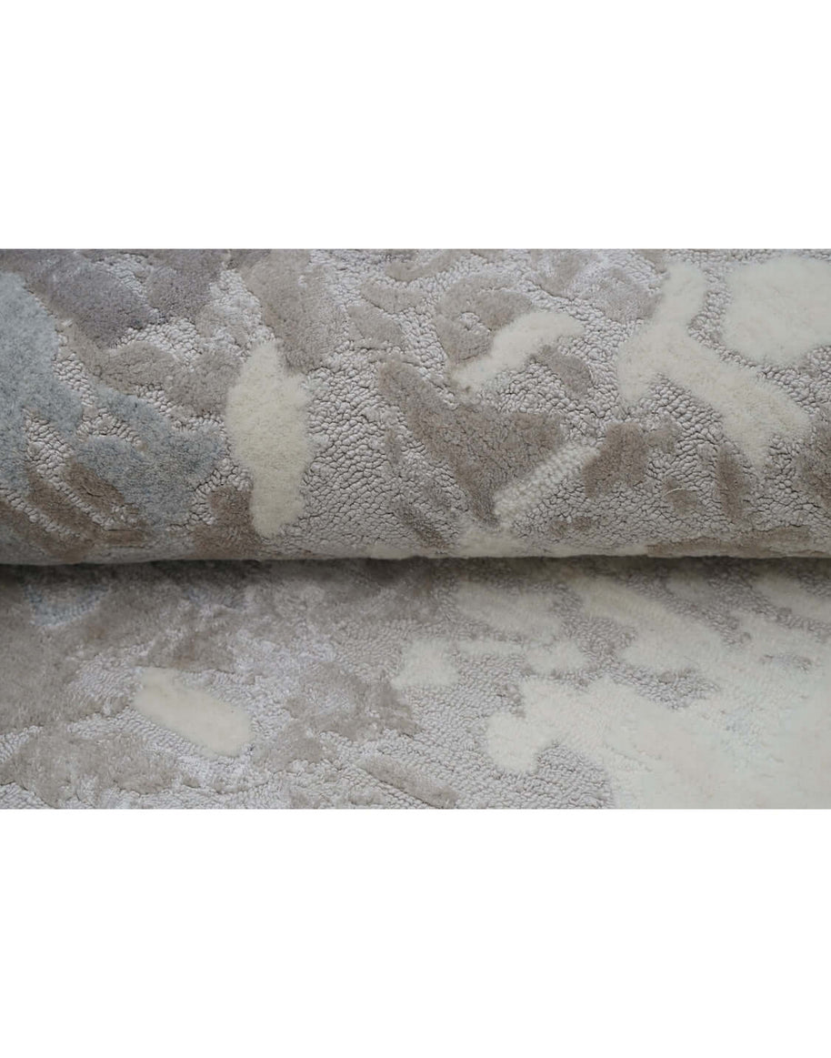 F R O S T luxury modern rug by Cherom, featuring a serene mix of charcoal, silver-grey, taupe, and ivory shades.