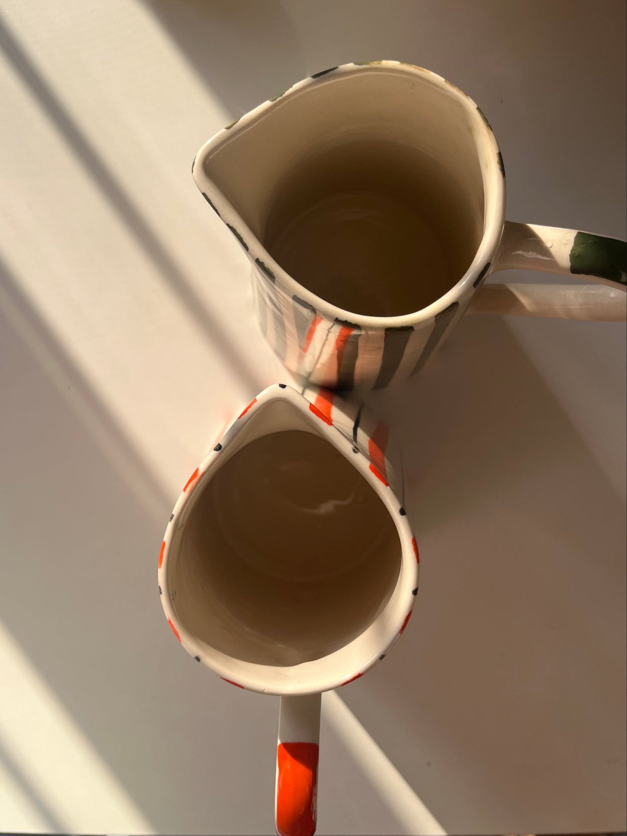 Top view of tall ceramic jug vase with hand-painted striped design