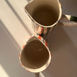 Top view of tall ceramic jug vase with hand-painted striped design