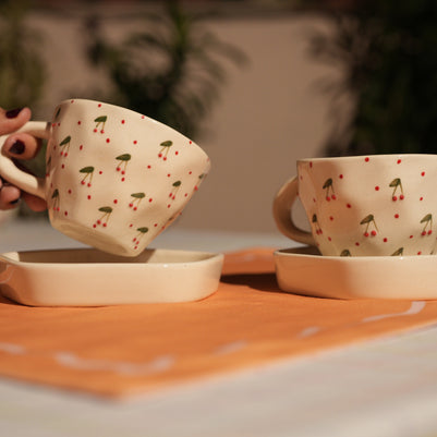 a pair of Cute ceramic mug with raised cherry accents