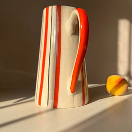 Marmalade ceramic jug vase styled in natural sunlight