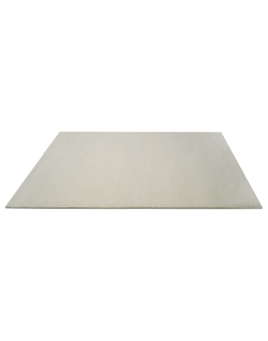 I C O N - M I L K rug made from 100% New Zealand wool, showcasing a classic design and hand-serged edges.