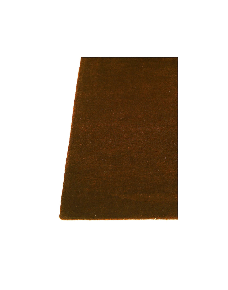 I C O N - A M B E R rug showcasing rich brown color and hand-tufted New Zealand wool craftsmanship.