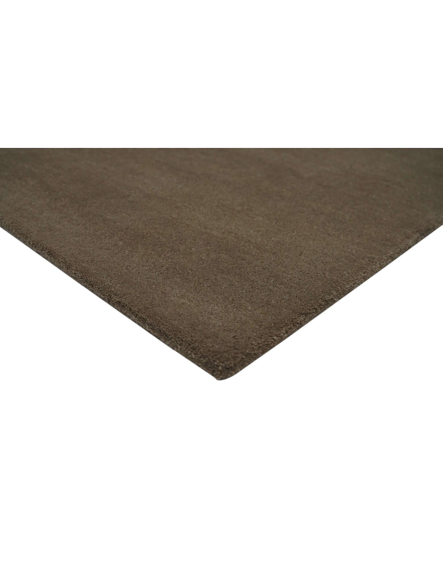 I C O N - T R U F F L E rug corner detail in rich brown, showcasing high density tufted craftsmanship and quality New Zealand wool.
