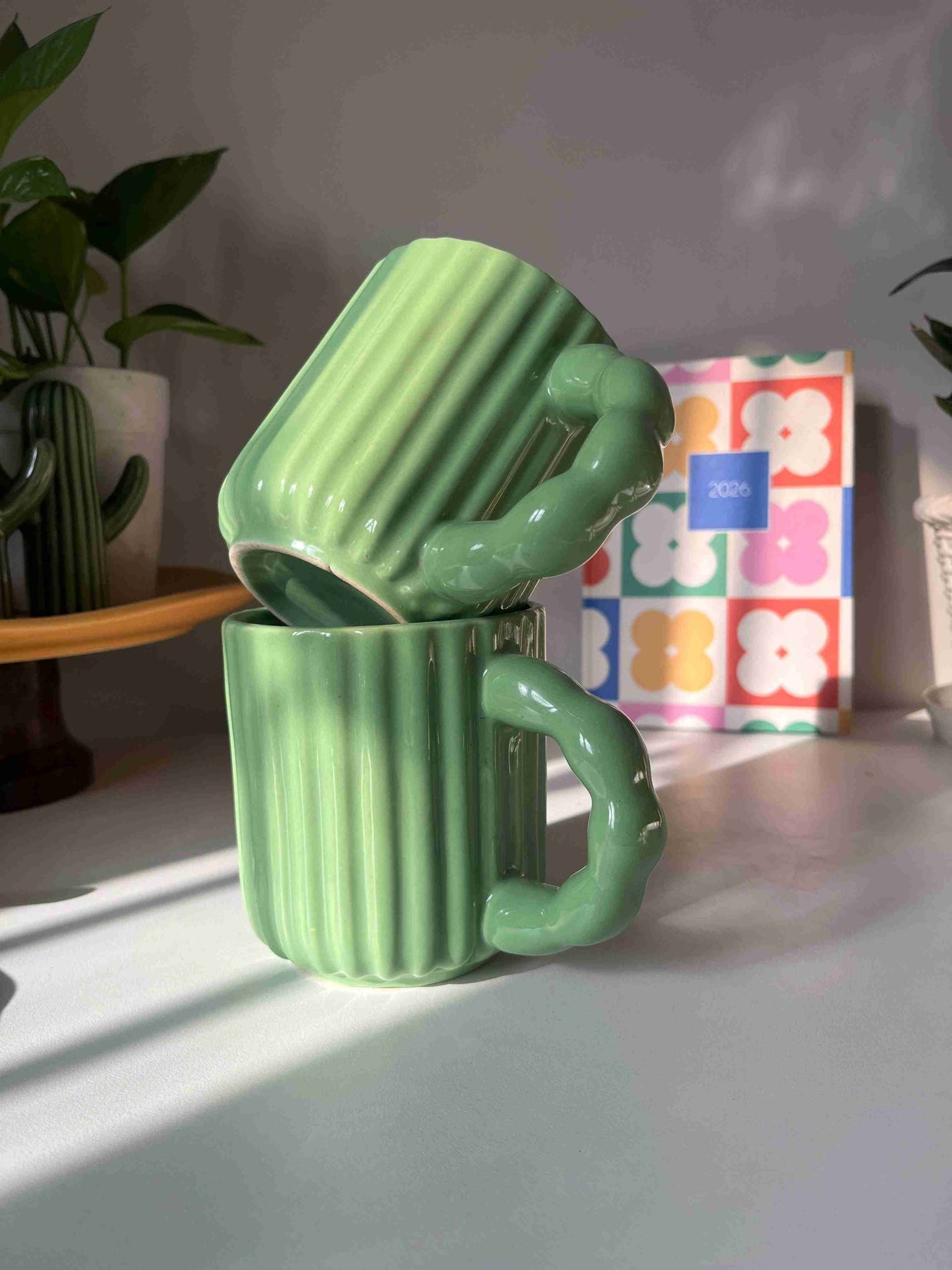 Kiwi Mug in glossy green ceramic with ribbed texture and sculptural handle by Madam Jan