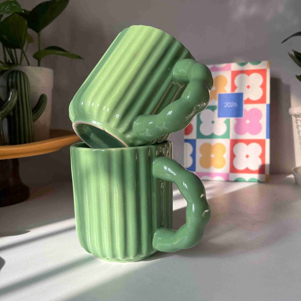 Kiwi Mug in glossy green ceramic with ribbed texture and sculptural handle by Madam Jan