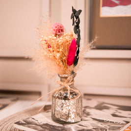 Minimal aesthetic silver vase with dried flower bunch styled on a wooden table for home decor inspiration