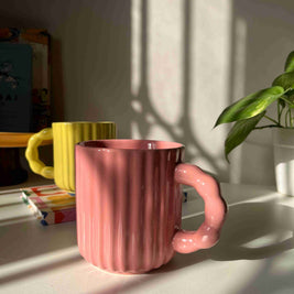 Modern ceramic mug with decorative beaded handle