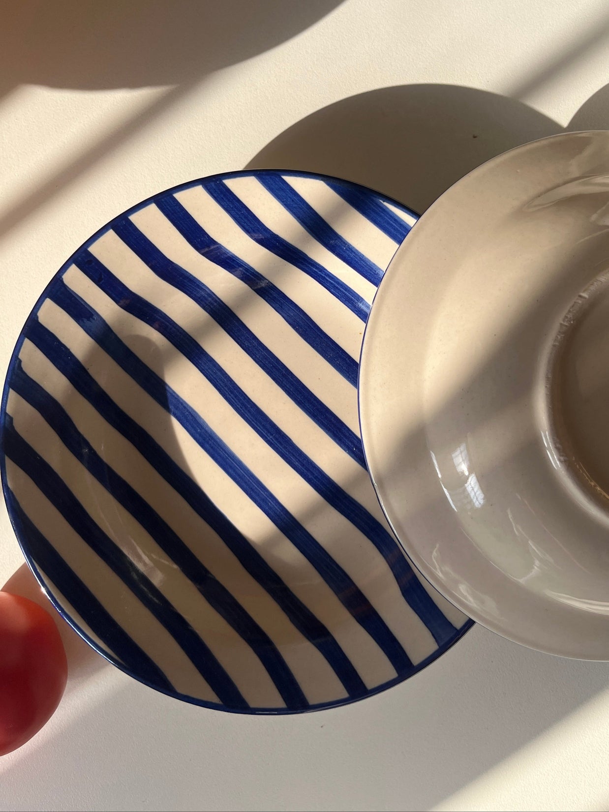 Ceramic serving plate with hand-painted blue striped design