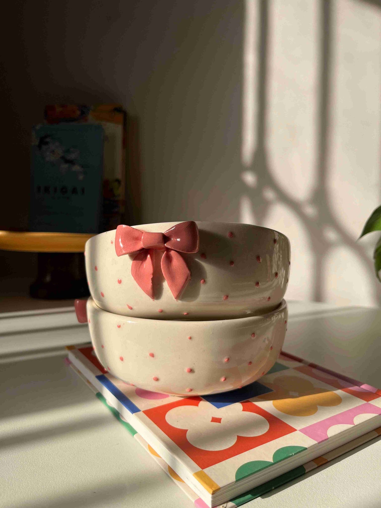 Glossy pink ceramic serving bowl with raised details