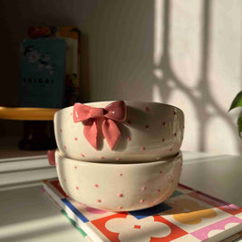 Glossy pink ceramic serving bowl with raised details