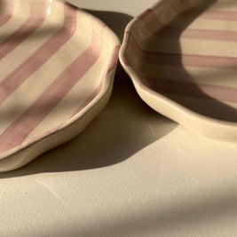 Close-up of a quarter ceramic plate with purple striped pattern