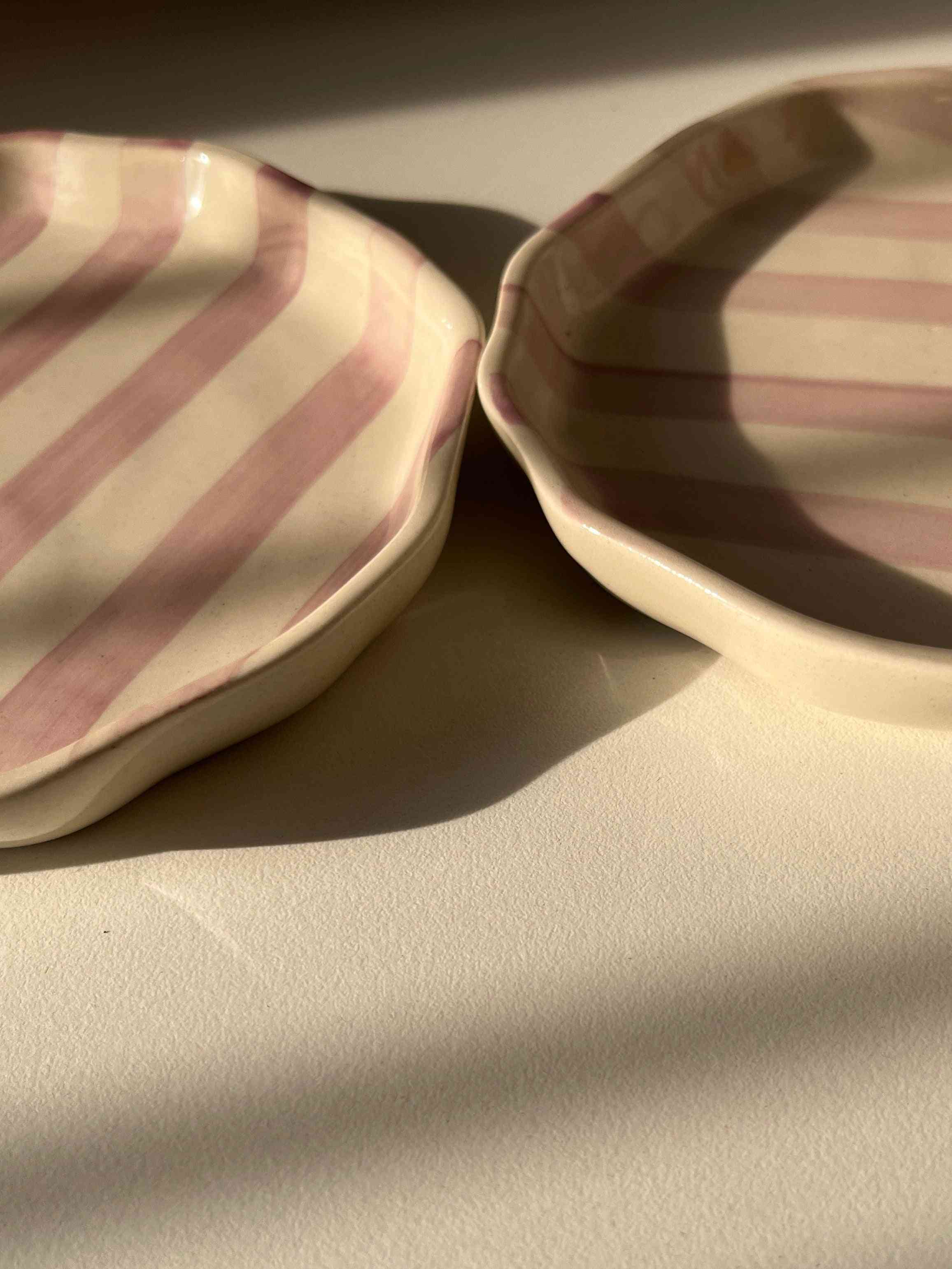 Close-up of a quarter ceramic plate with purple striped pattern