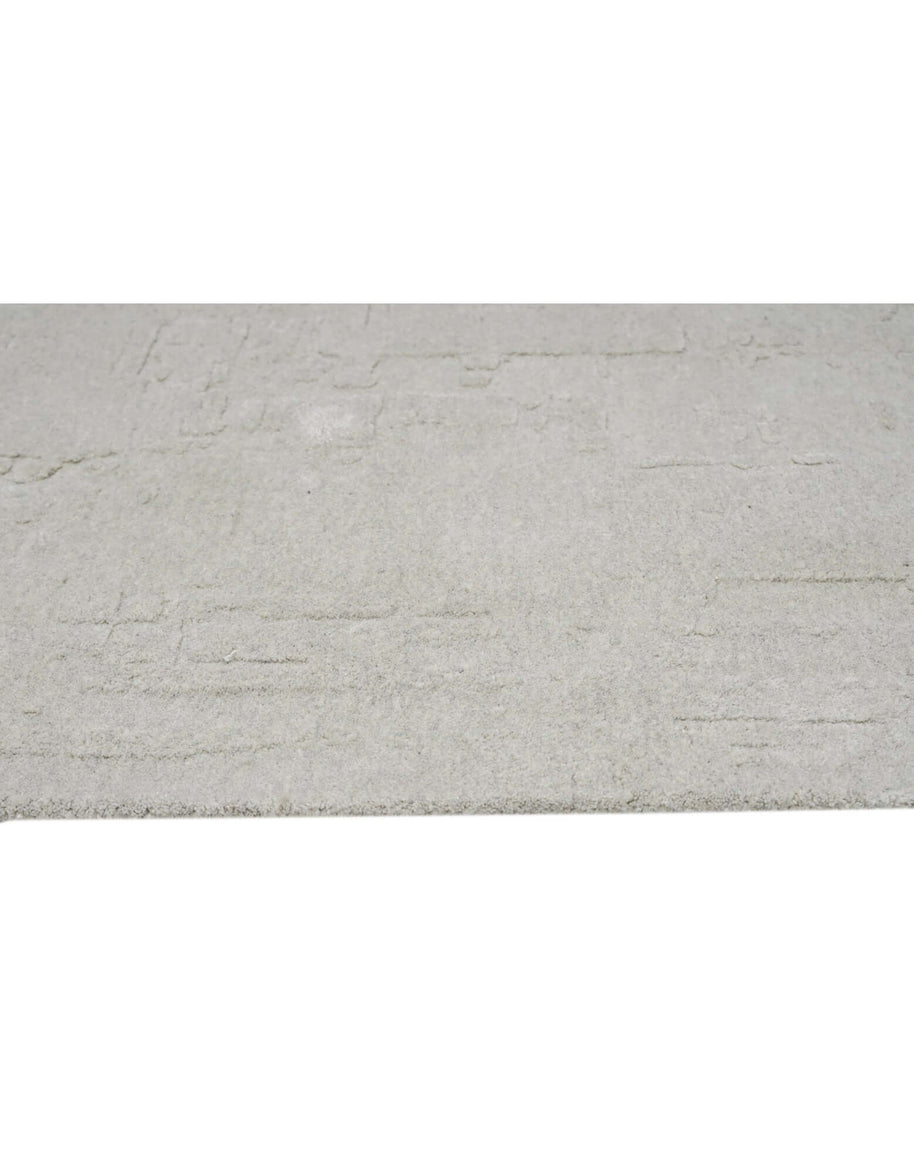 S C U L P T E D - U R B A N A luxury modern rug by Cherom - soft grey tone with carved texture.