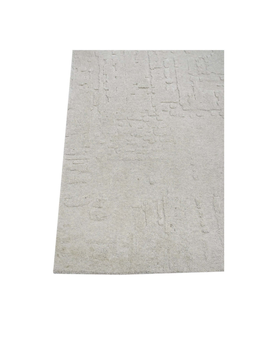 S C U L P T E D - U R B A N A luxury modern rug by Cherom, featuring a soft grey tone and carved texture.