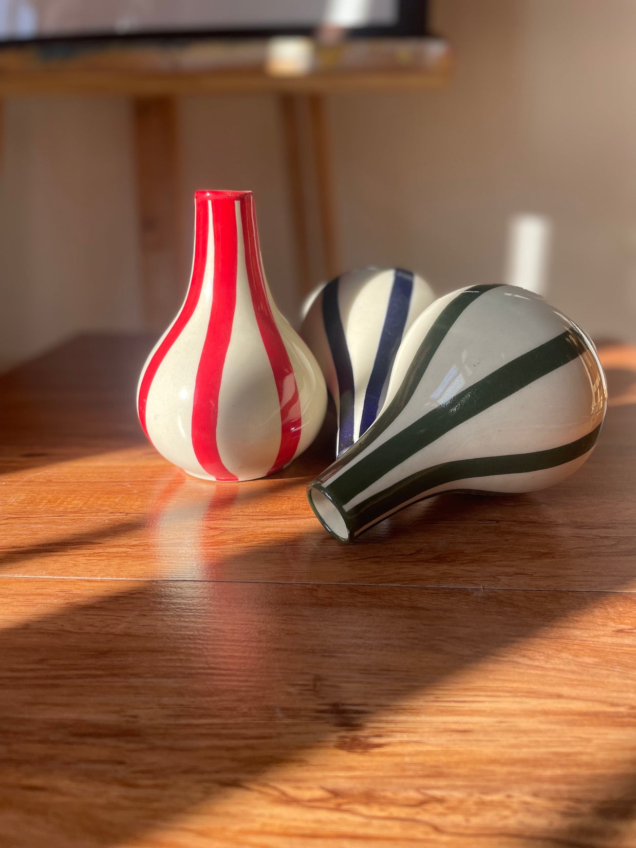 Small striped Piccolo vases styled together on a shelf as home decor.