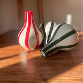 Small striped Piccolo vases styled together on a shelf as home decor.