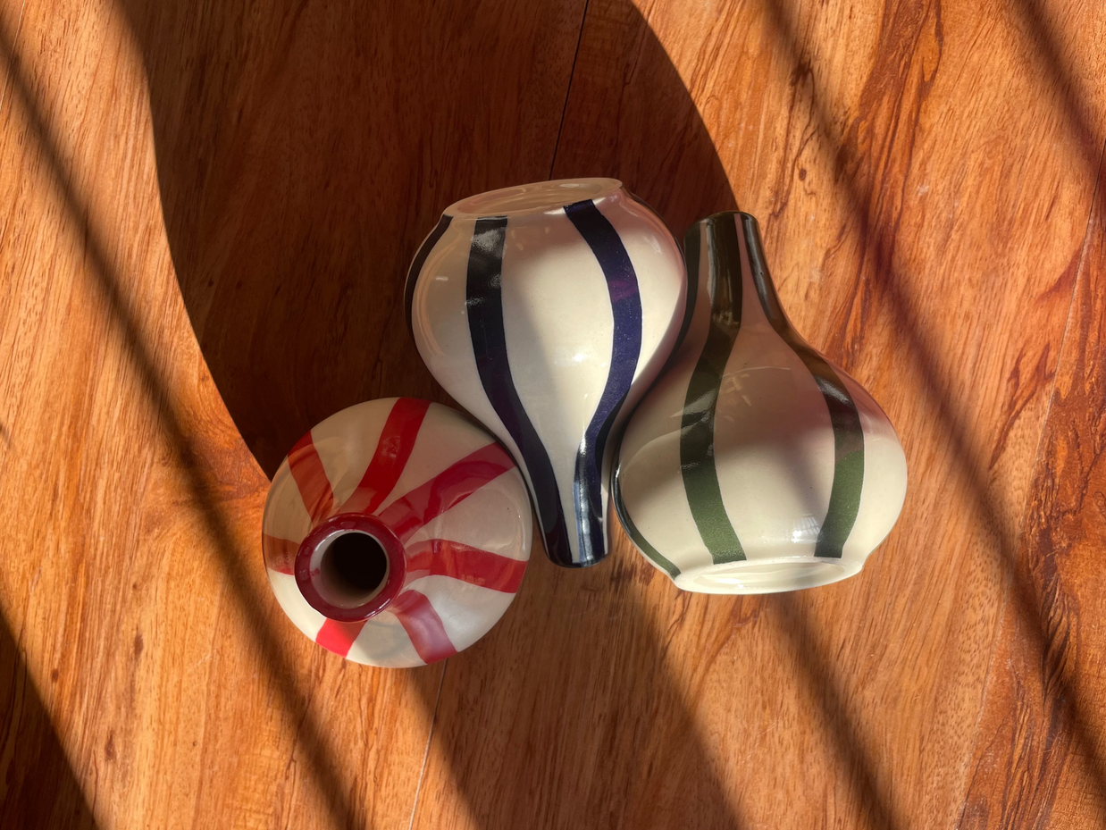 Top and front view of the Stems & Stripes vase trio with three petite striped vases.