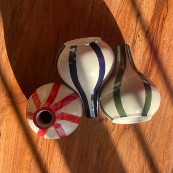 Top and front view of the Stems & Stripes vase trio with three petite striped vases.