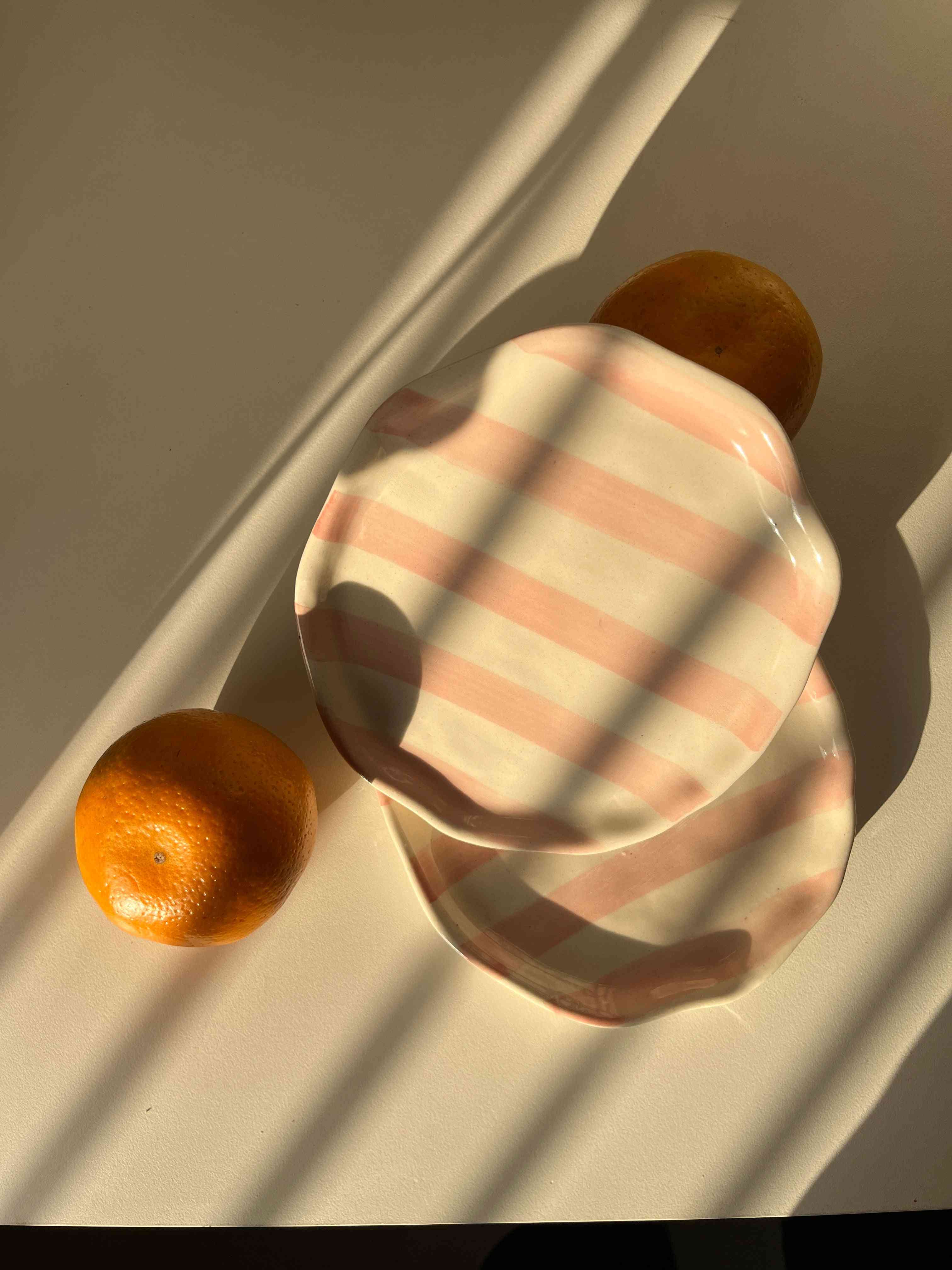 Pink Taffy ceramic plate with hand-painted blush stripes and glossy finish