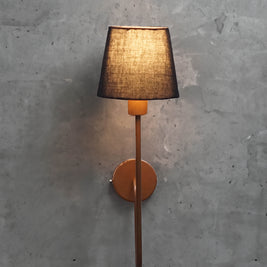 Modern industrial wall lamp featuring a minimalist black shade and elegantly curved copper arm