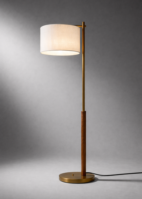 Floor lamp with a white shade and gold base on a gray background