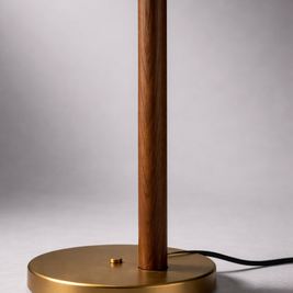 Table lamp with wooden and brass design on a gray background